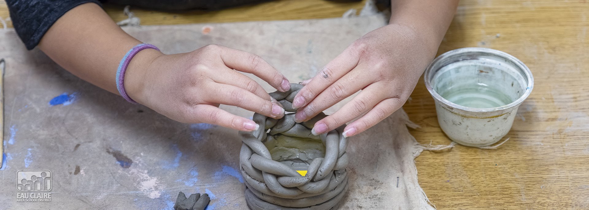 student with clay 